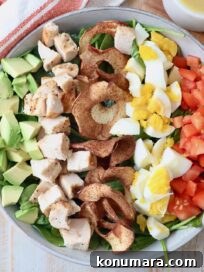 cobb salad in bowl with apple chips