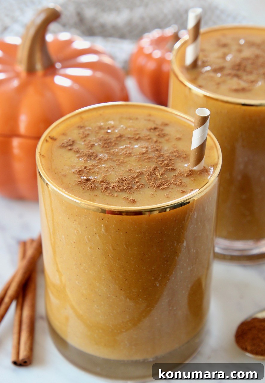 pumpkin smoothie in glass with straw