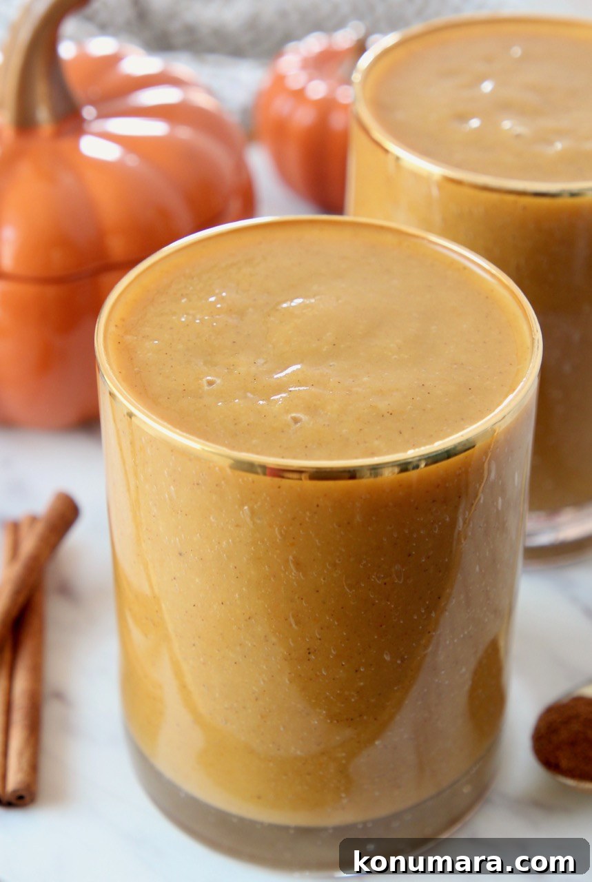 pumpkin smoothie in glass with gold rim