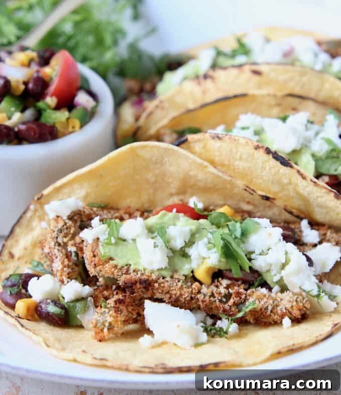 Tacos on plate filled with crispy cactus strips and crumbled queso fresco