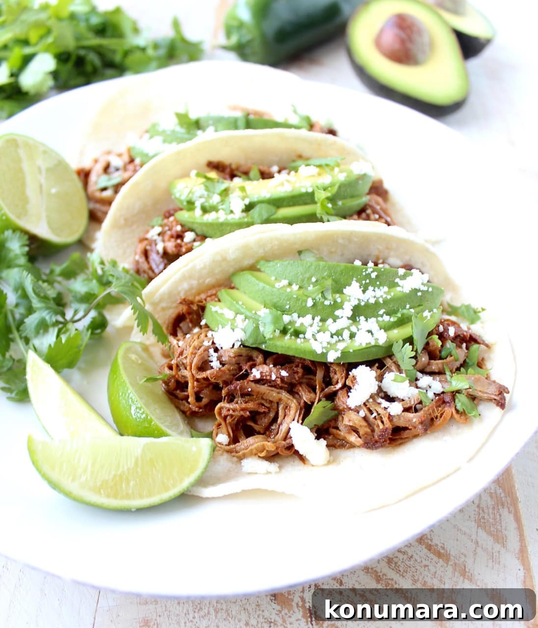 Slow Cooker Chipotle Honey Pulled Pork Tacos Recipe 3 Pulled pork served in soft tortillas topped with avocado and cotija cheese.