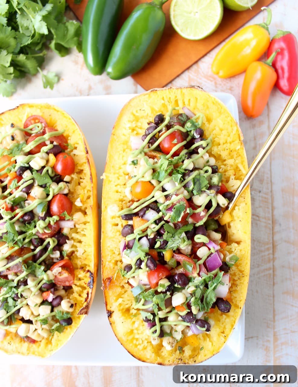 roasted spaghetti squash filled with black bean corn salsa on plate with fork