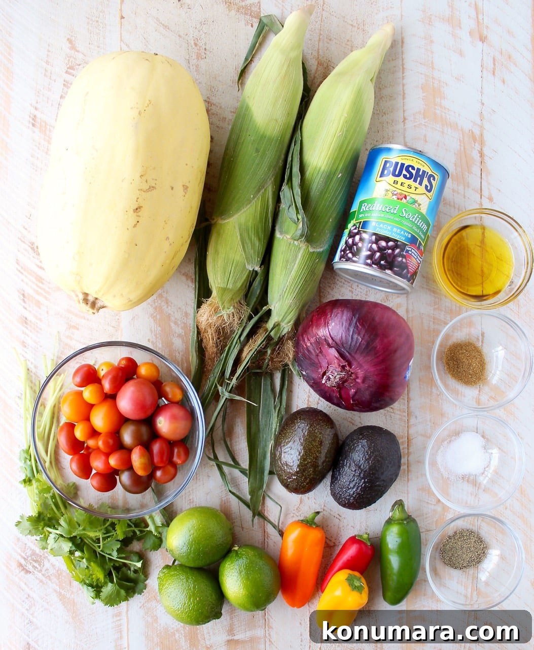 ingredients for stuffed spaghetti squash on white wood board