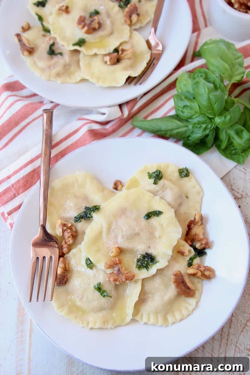 Overhead shot of raviolis on two plates with copper fork