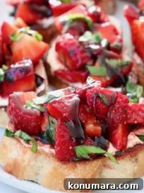 diced strawberries with fresh basil on a toasted piece of bread on a plate