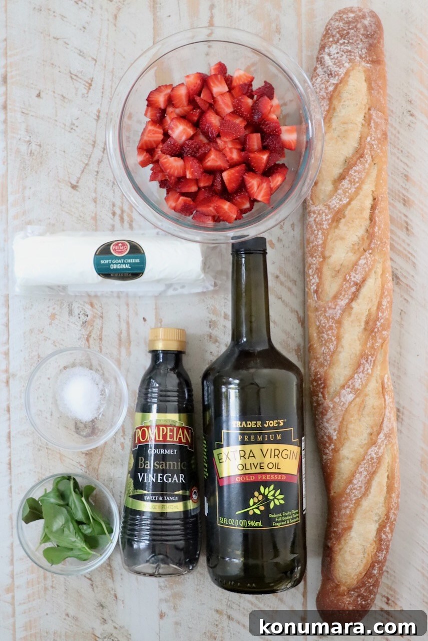 ingredients for strawberry balsamic bruschetta on a white wood board