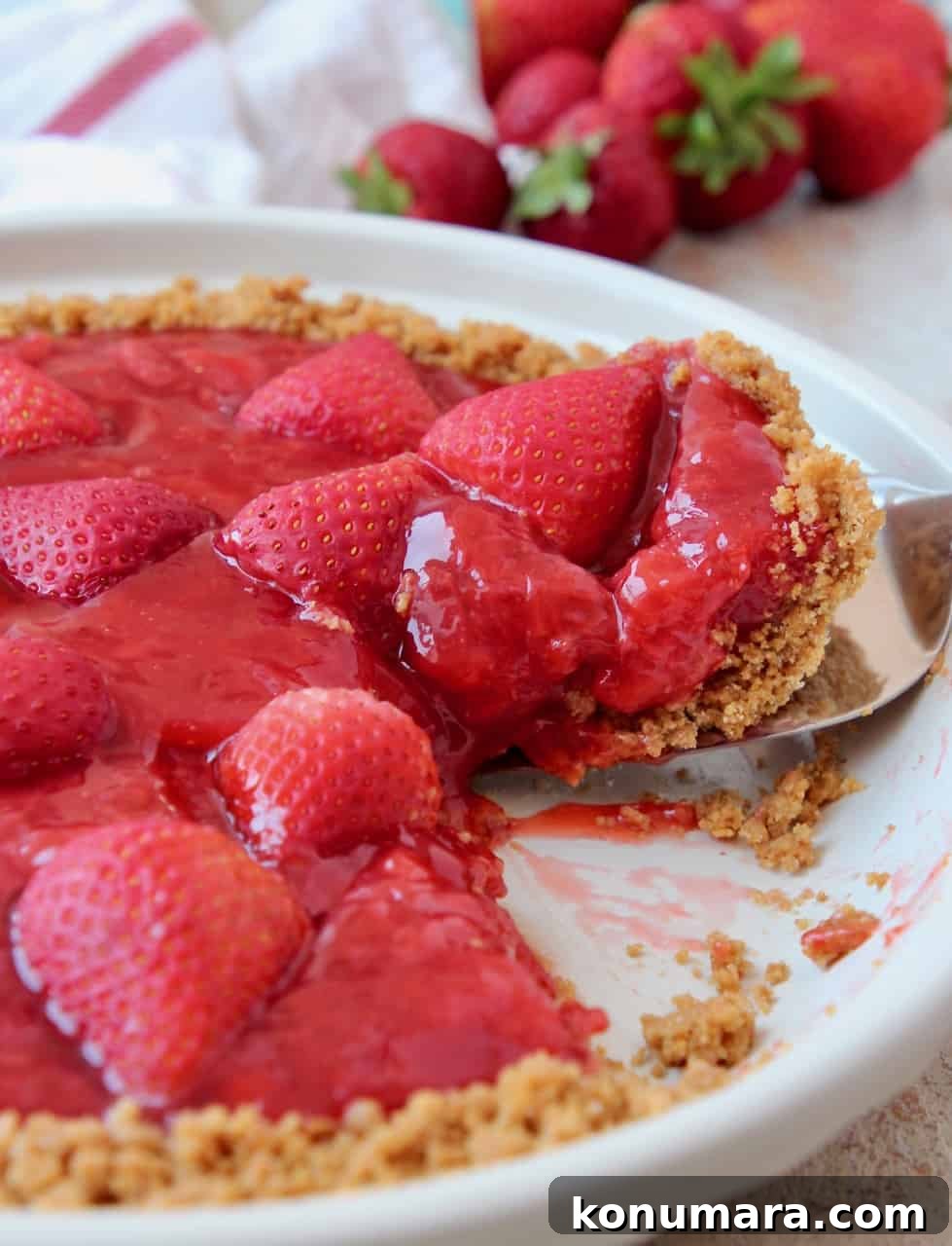 Fresh Strawberry Pie Recipe with Graham Cracker Crust 2 Slice of strawberry pie coming out of pie plate