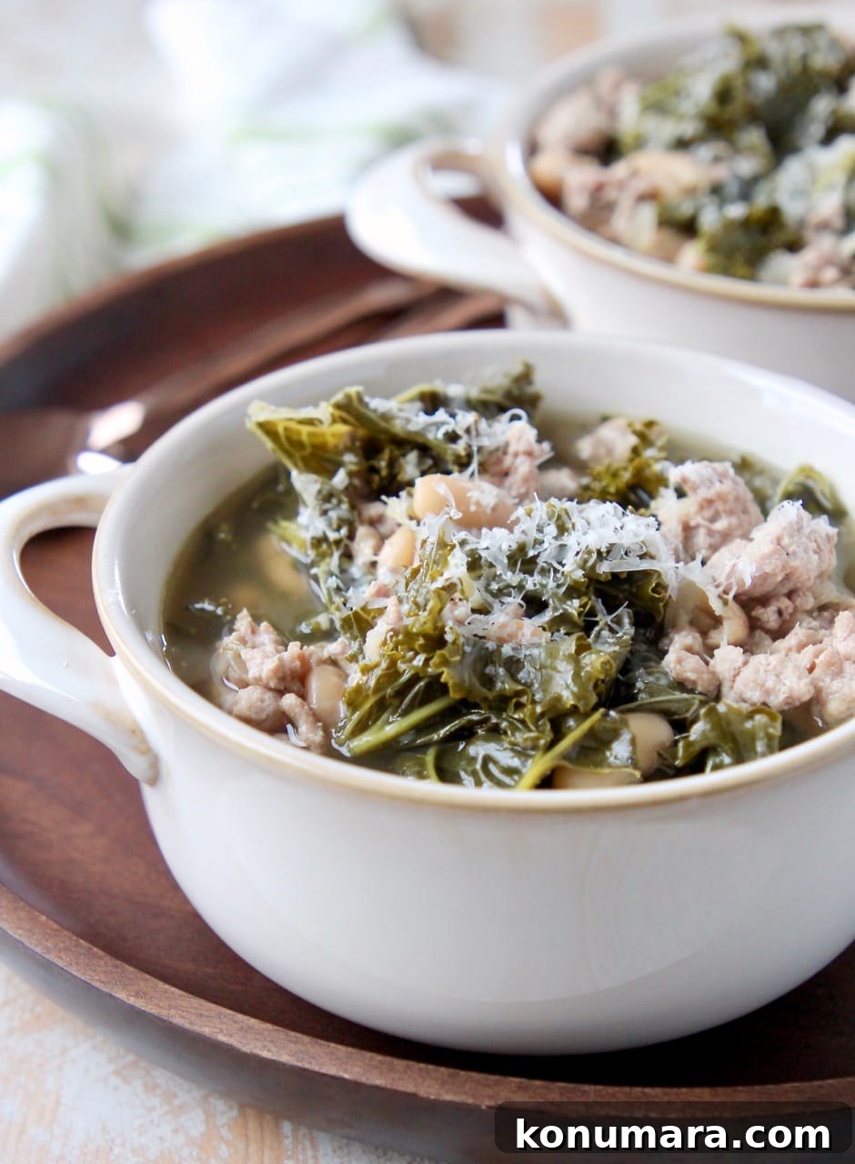 Hearty Slow Cooker Turkey and Kale Soup 2 Ground turkey and kale soup in white soup crock on wood tray