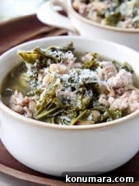 Hearty Slow Cooker Turkey and Kale Soup 5 Kale turkey soup in white soup crock on dark wood tray