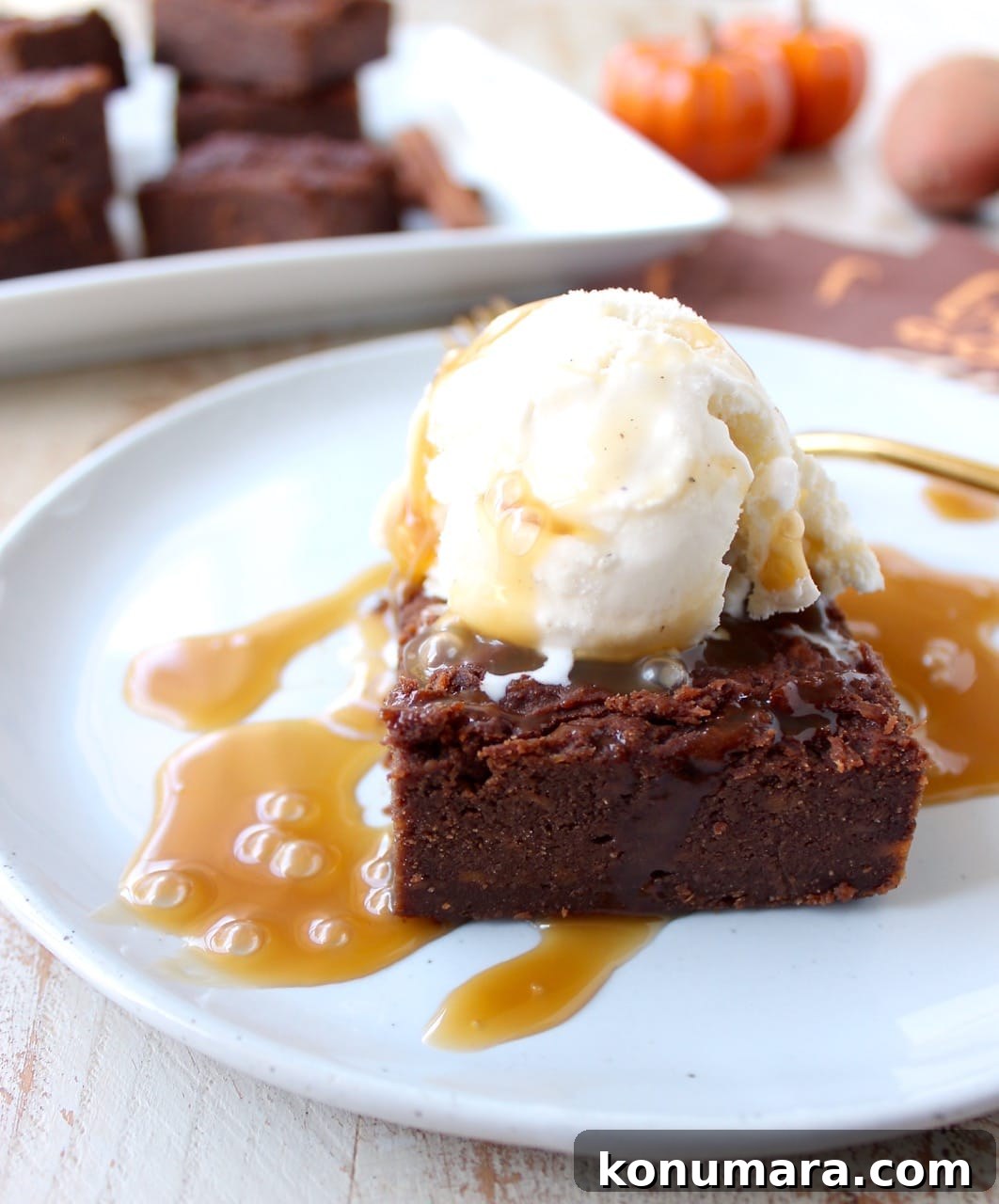 Gluten Free Sweet Potato Brownies are a rich and creamy treat, perfect for fall, topped with vanilla bean ice cream and drizzled with caramel syrup!
