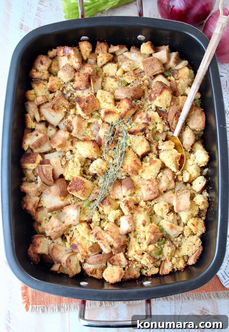 Gluten Free Thanksgiving Stuffing Recipe 2 Gluten free cornbread stuffing in roasting pan with spoon and fresh thyme sprigs