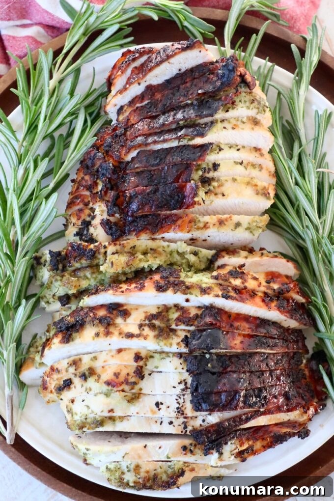 Herb-Rubbed Oven-Roasted Turkey Breast 5 sliced turkey breast on plate with crispy brown skin