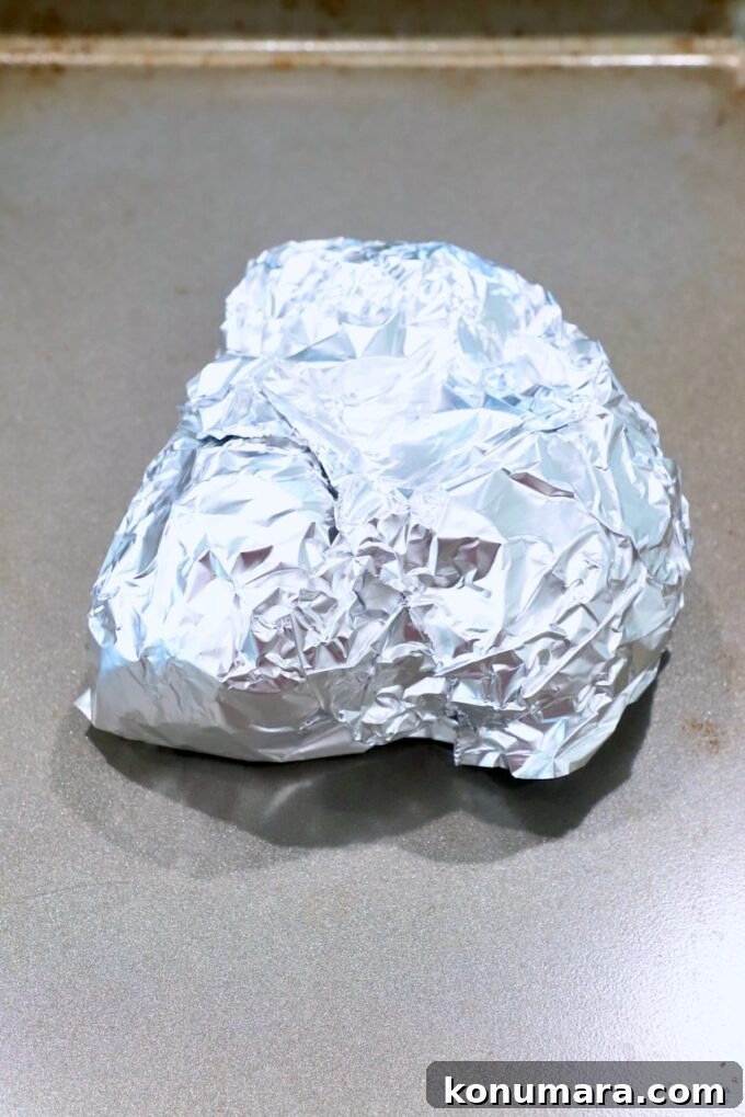 beets wrapped in foil on baking sheet