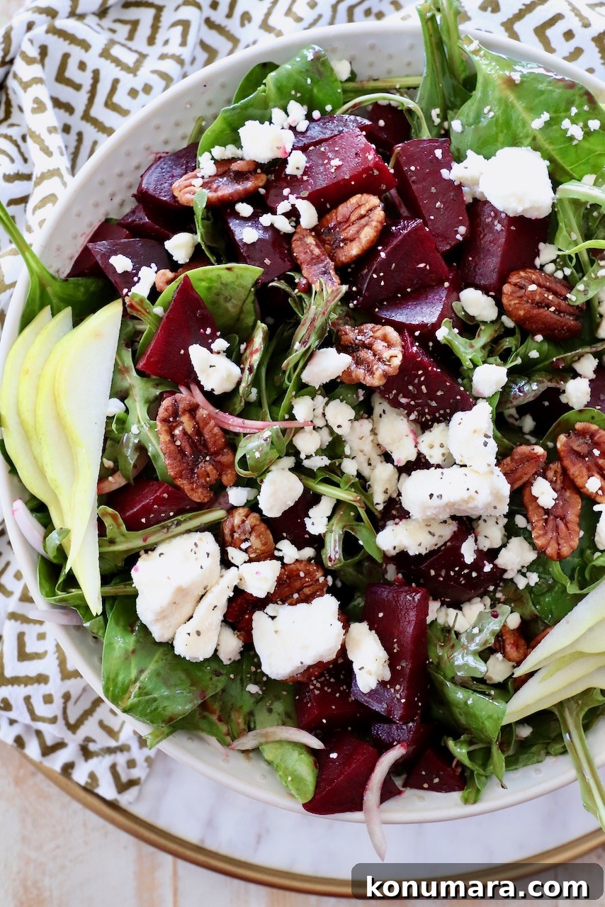 beet salad in bowl topped with feta and pear slices
