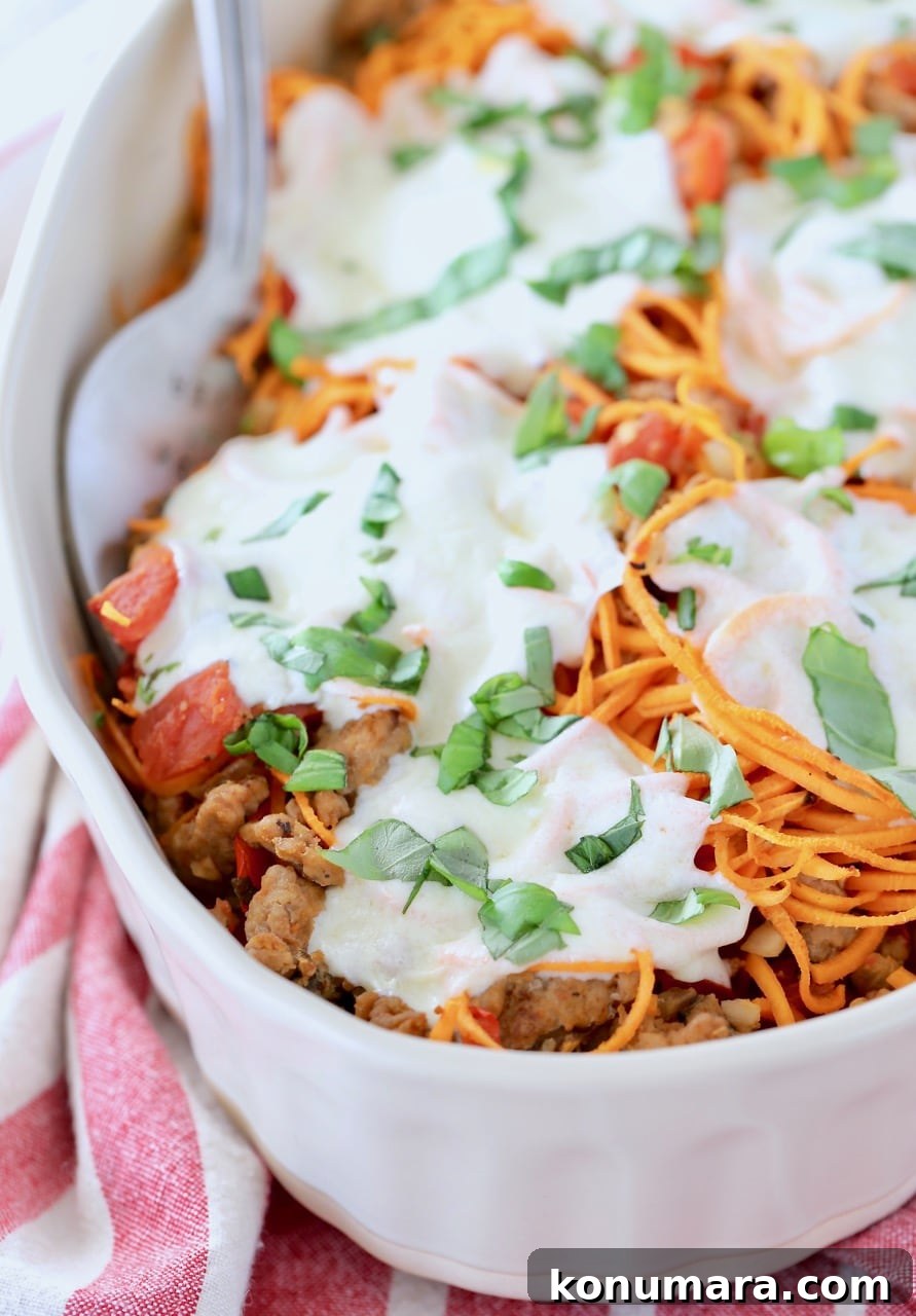 Baked Italian Turkey and Sweet Potato Casserole 2 Italian turkey sweet potato casserole in oval baking dish with large serving fork