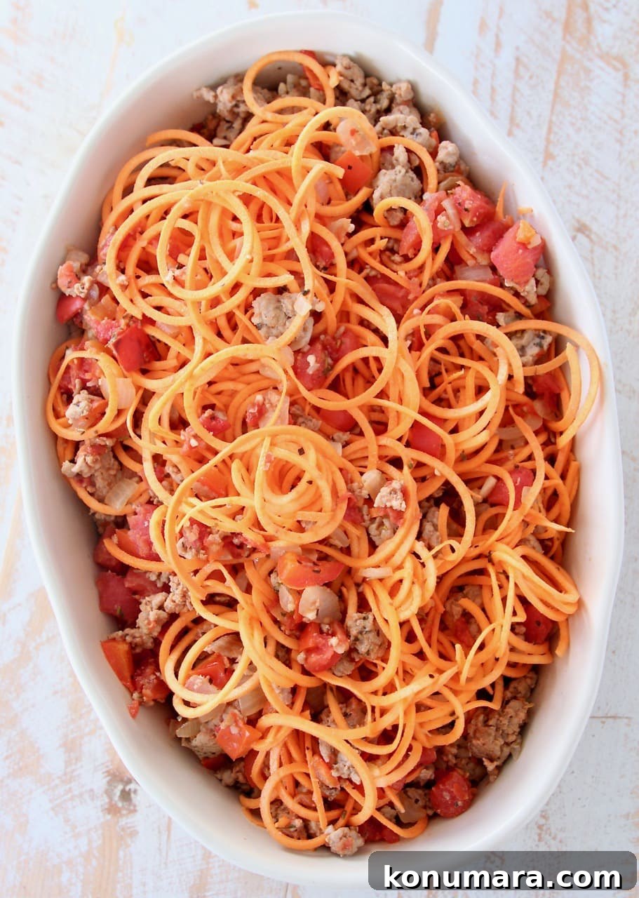 Baked Italian Turkey and Sweet Potato Casserole 4 Sweet potato noodles, ground turkey and tomatoes in an oval baking dish
