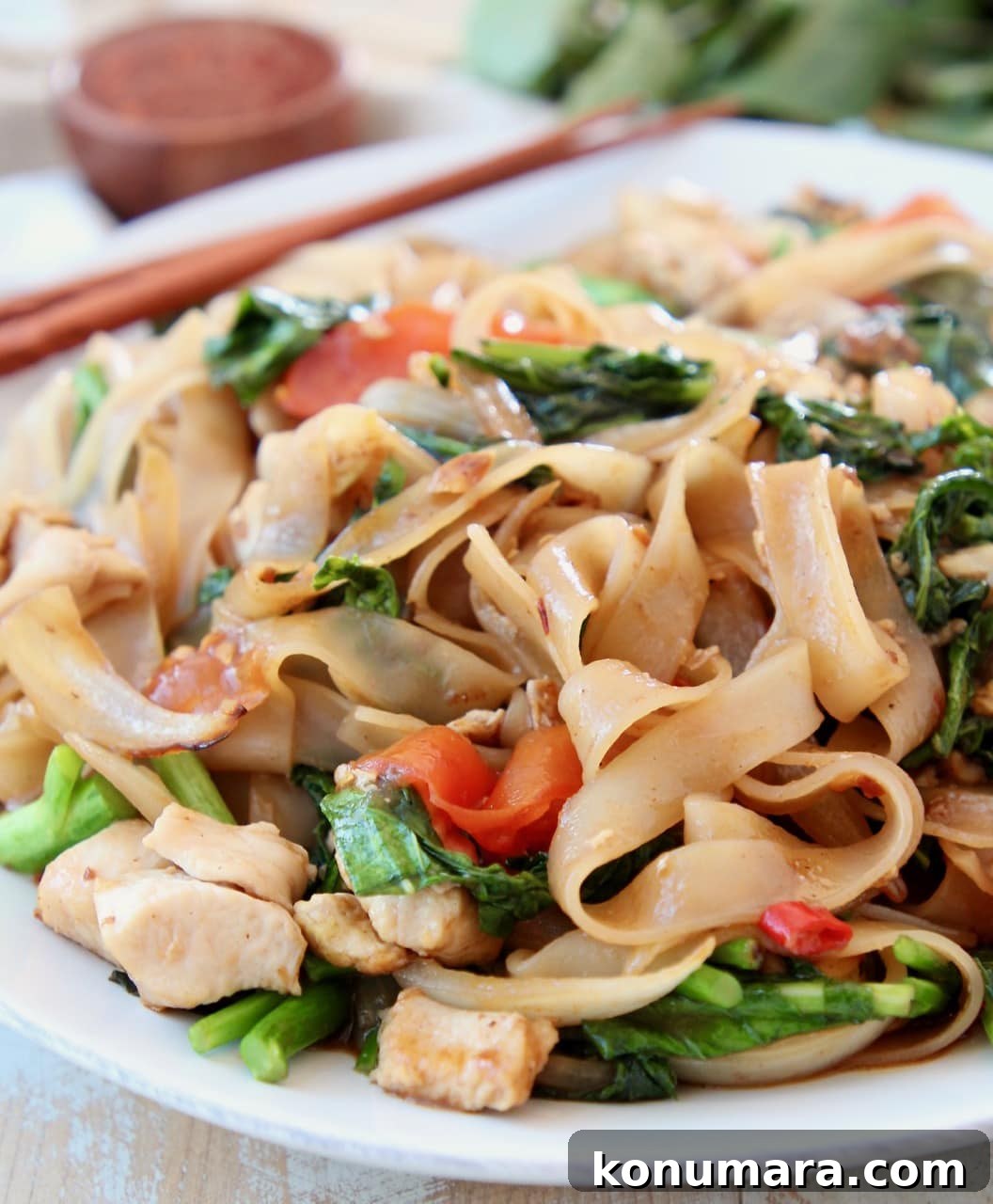 Authentic Thai Drunken Noodles (Pad Kee Mao) Recipe 11 Thai wide noodles stir fried with Chinese broccoli on white plate