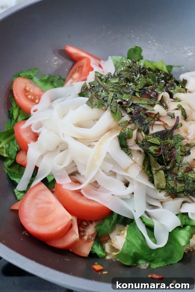 Authentic Thai Drunken Noodles (Pad Kee Mao) Recipe 8 rice noodles in large wok with vegetables and sauce