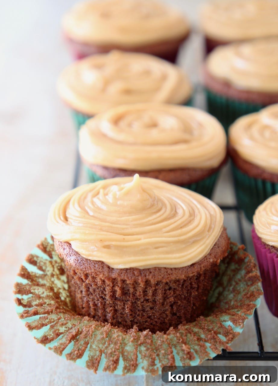 Gluten Free Peanut Butter Chocolate Cupcakes 5 Chocolate cupcake with peanut butter frosting, sitting on cupcake liner, peeled from the cupcake