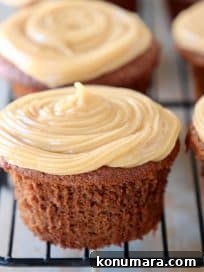 Gluten Free Peanut Butter Chocolate Cupcakes 6 Chocolate cupcake with peanut butter frosting on black wire baking rack