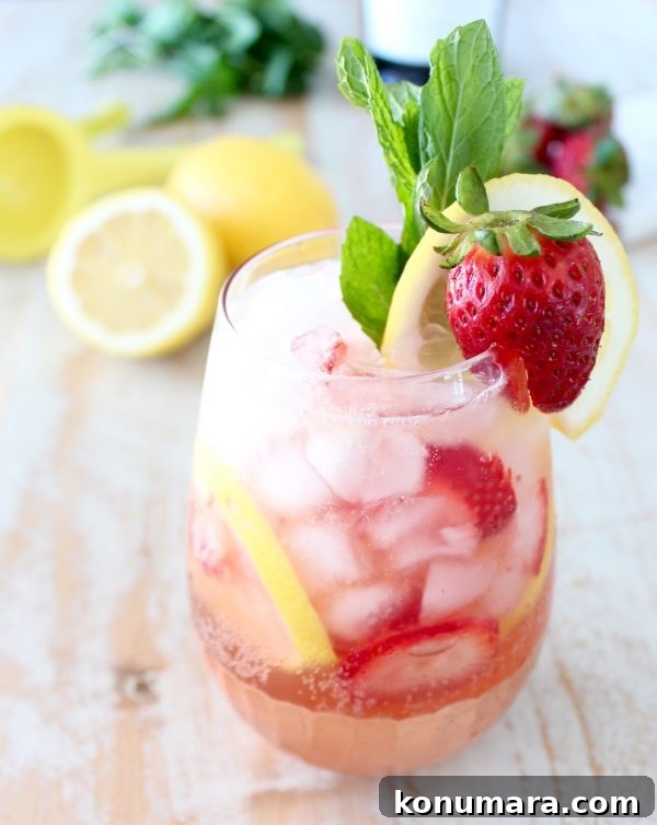 strawberry lemon prosecco sangria in stemless wine glass