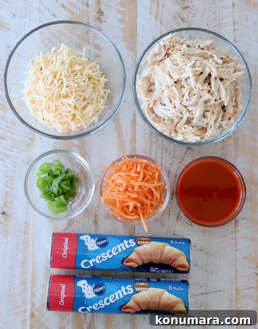 ingredients for buffalo chicken taco ring on white wood board