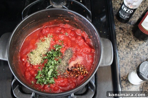 Mediterranean Sausage-Stuffed Shells Recipe 5 Red Wine Tomato Sauce in a pot on the stove.