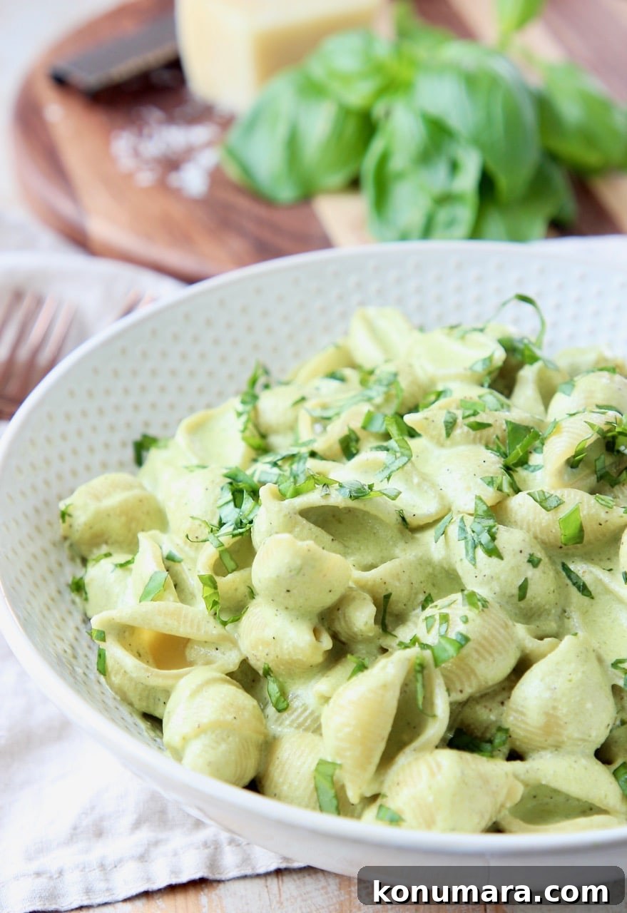 Cheesy Basil Pesto Pasta Recipe with Parmesan 3 Cheesy pesto pasta shells in white bowl