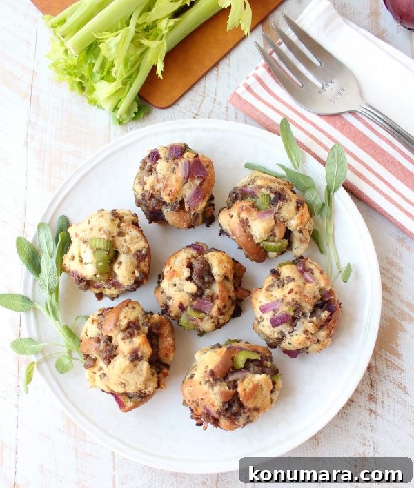 Oven-Baked Sausage Stuffing Balls Recipe 6 cooked sausage stuffing balls on plate with fresh sage leaves