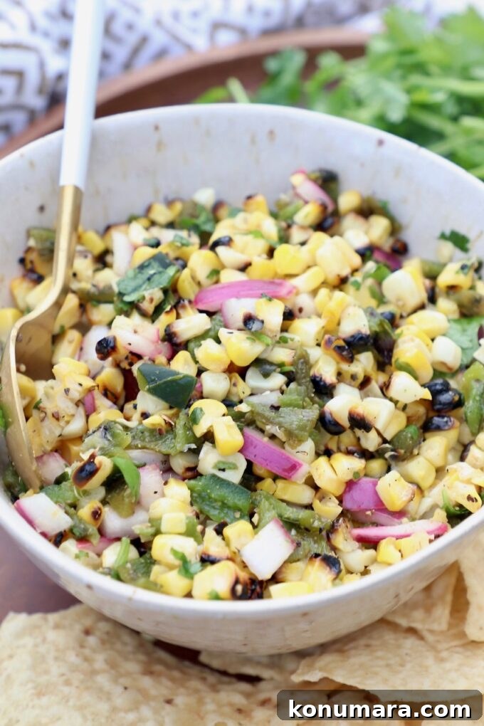 corn salsa in white bowl with spoon
