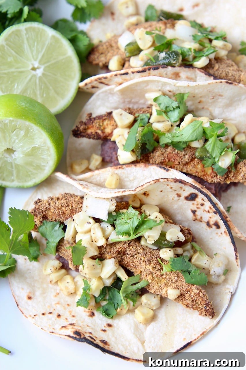 Overhead shot of crispy avocado tacos on plate with fresh cilantro