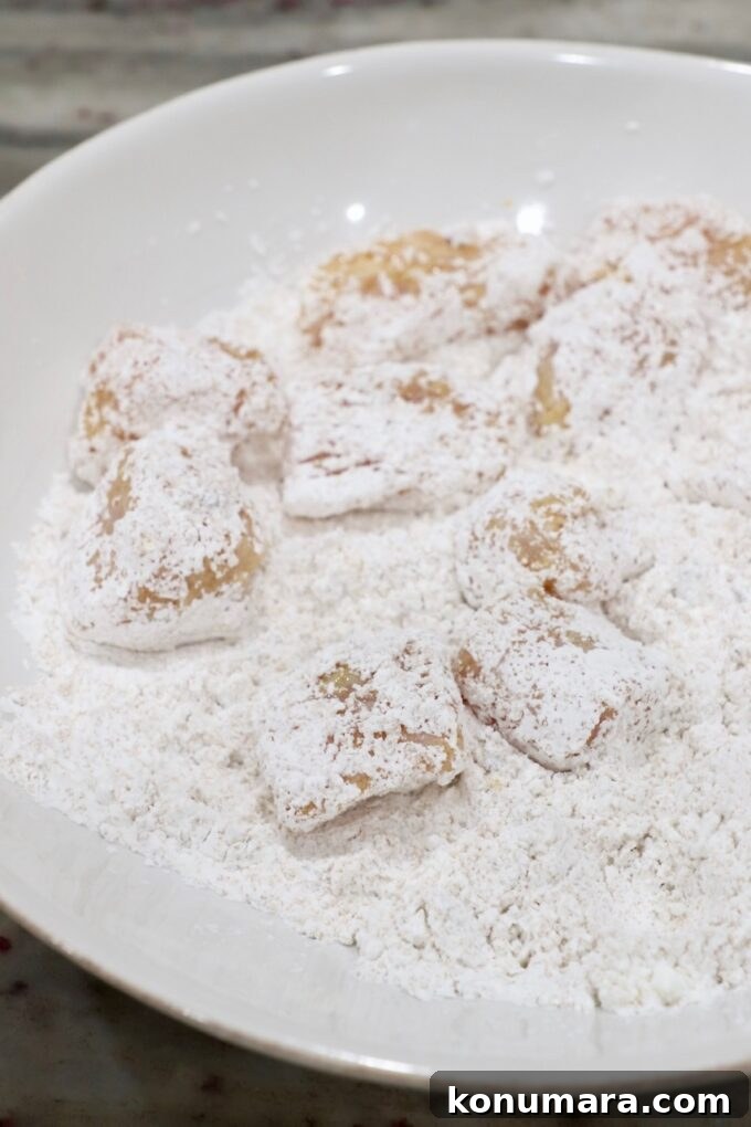 cornstarch coated pieces of chicken in a bowl