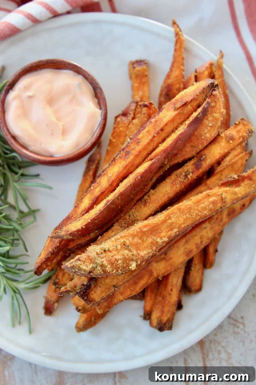 Sweet potato fries on plate with dipping sauce in a small bowl on the side