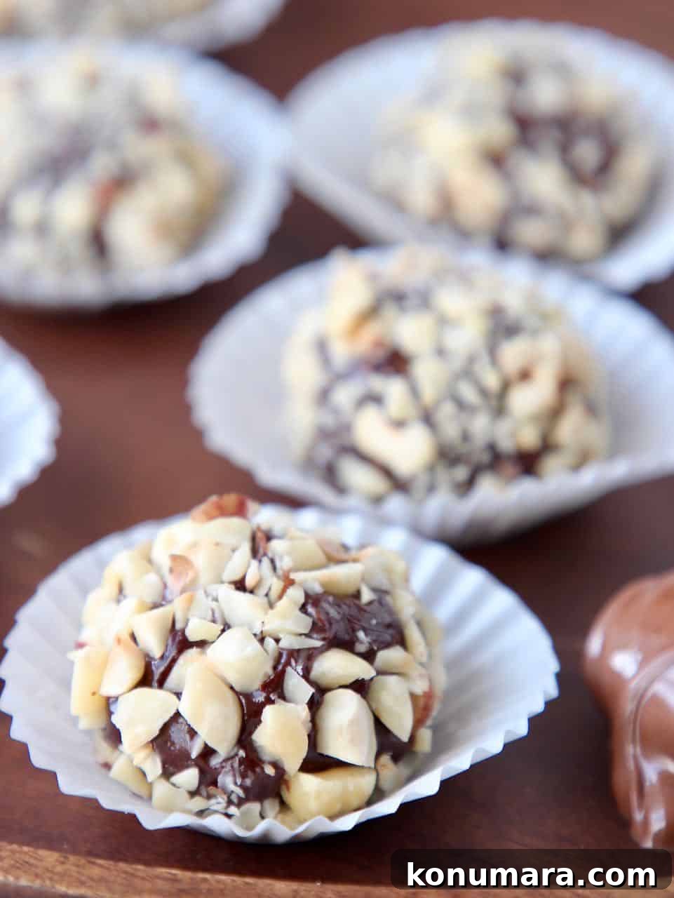Hazelnut chocolate truffles in white candy paper cups
