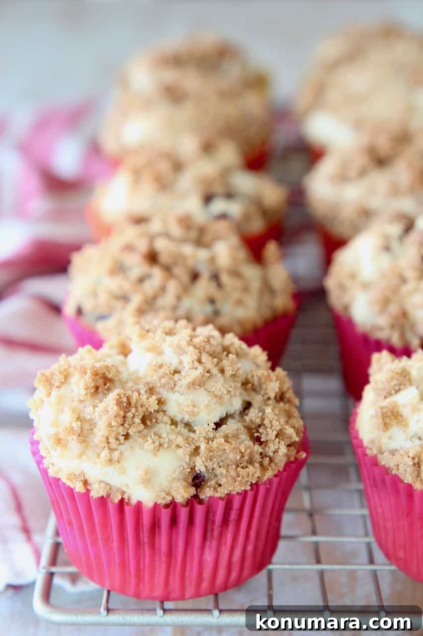 Maple bacon muffins in pink muffin liners sitting on wire baking rack