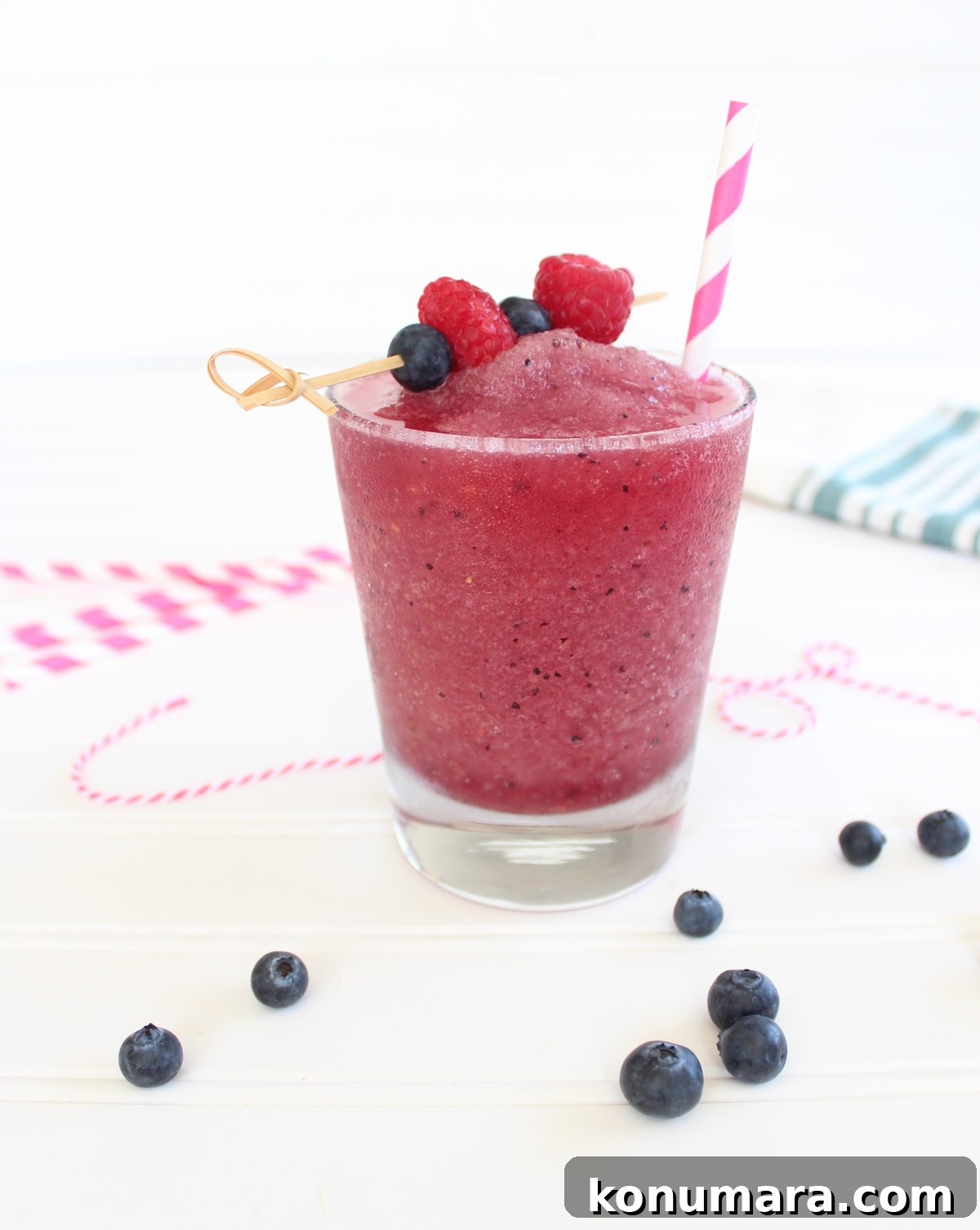 Frozen Fruit Sangria in a glass topped with a skewer of fresh fruit