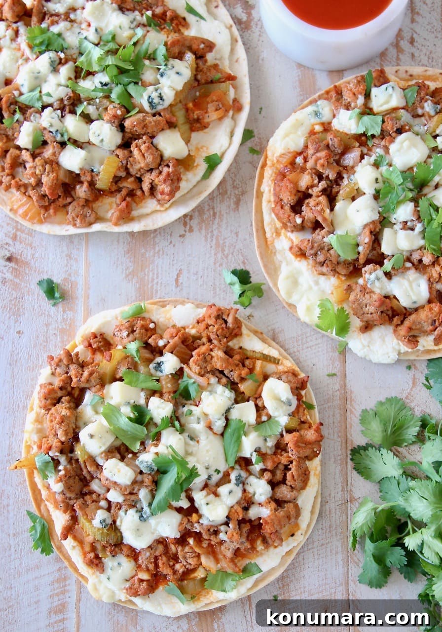 Buffalo Turkey Grilled Flatbread with Melted Cheese 2 Overhead shot of grilled buffalo turkey flatbread pizzas topped with fresh cilantro