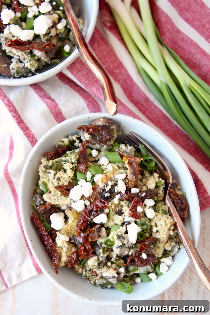 Slow-Cooker Greek Breakfast Casserole with Feta and Spinach 2 Breakfast casserole with eggs, feta cheese and sun dried tomatoes and in bowls with green onions on the side