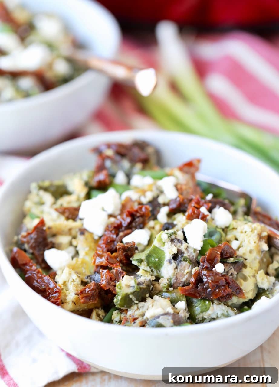 Slow-Cooker Greek Breakfast Casserole with Feta and Spinach 5 Greek eggs with feta cheese and sun dried tomatoes in bowl