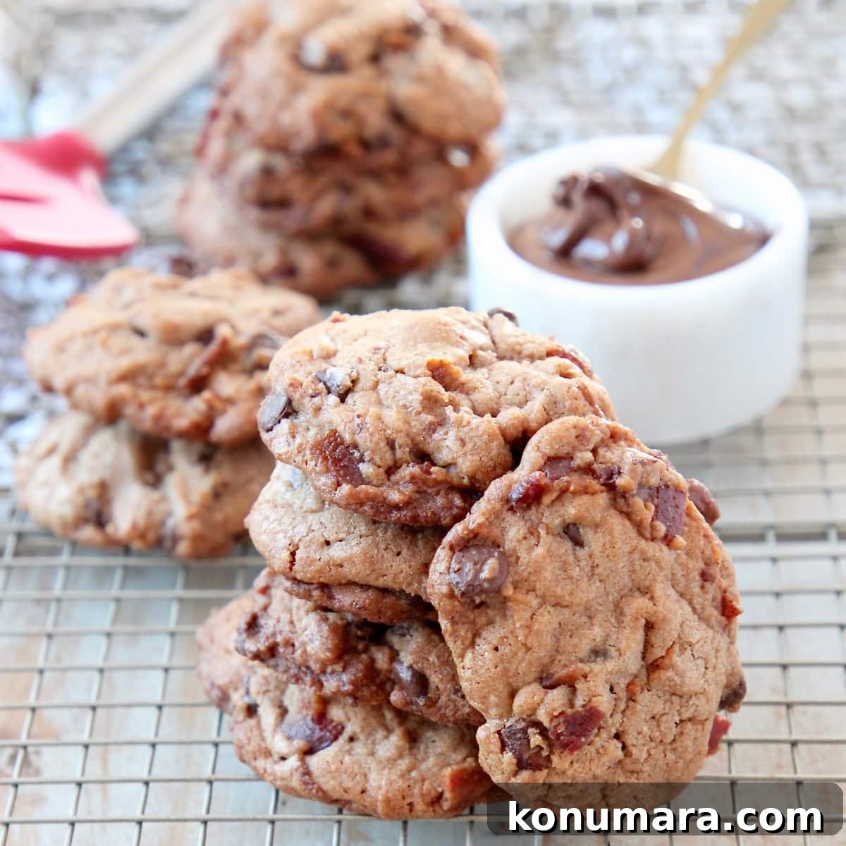 Nutella Bacon Chocolate Chip Cookies Recipe 2 Bacon Chocolate Chip Cookies stacked up on wire baking rack with bowl of nutella
