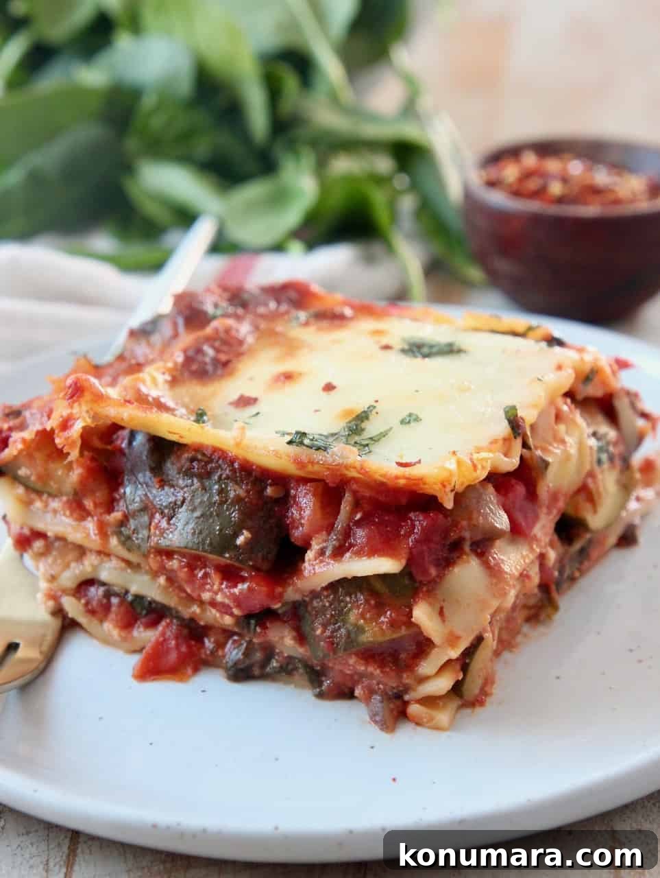 Classic Vegetarian Lasagna Recipe with Spinach and Ricotta 7 slice of vegetable lasagna on plate with fork