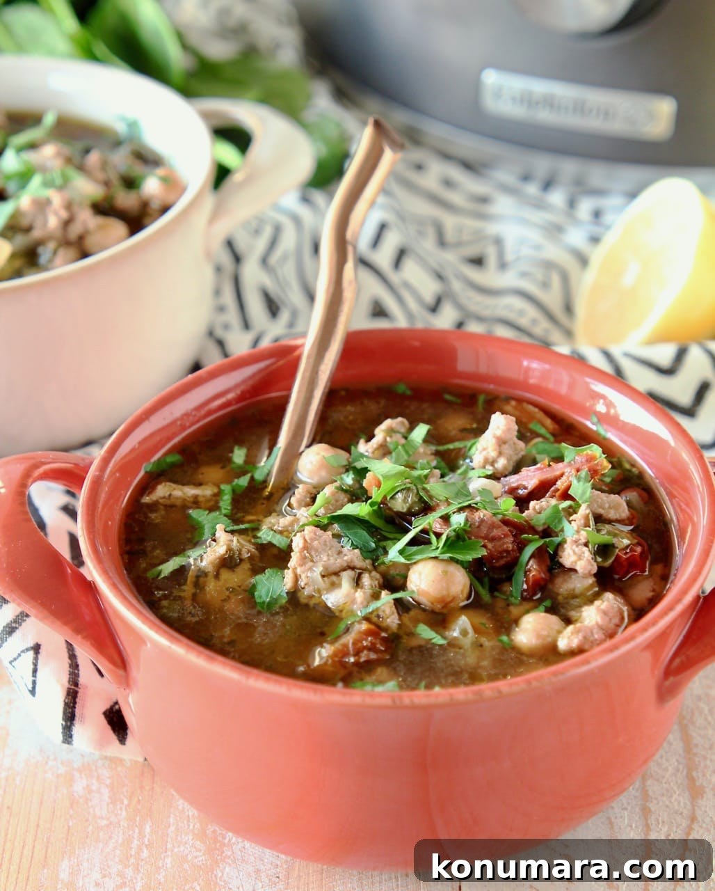 Greek Turkey Lemon Soup with Orzo 3 Greek turkey soup with chickpeas and spinach in orange bowl with copper spoon