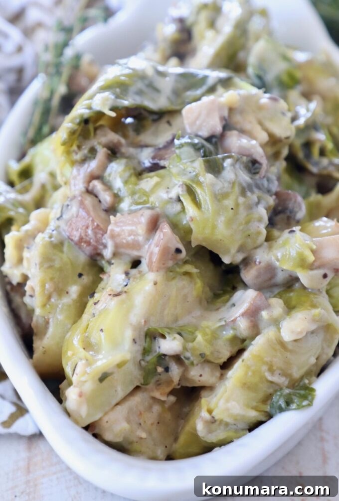 creamy baked brussel sprouts in white serving dish