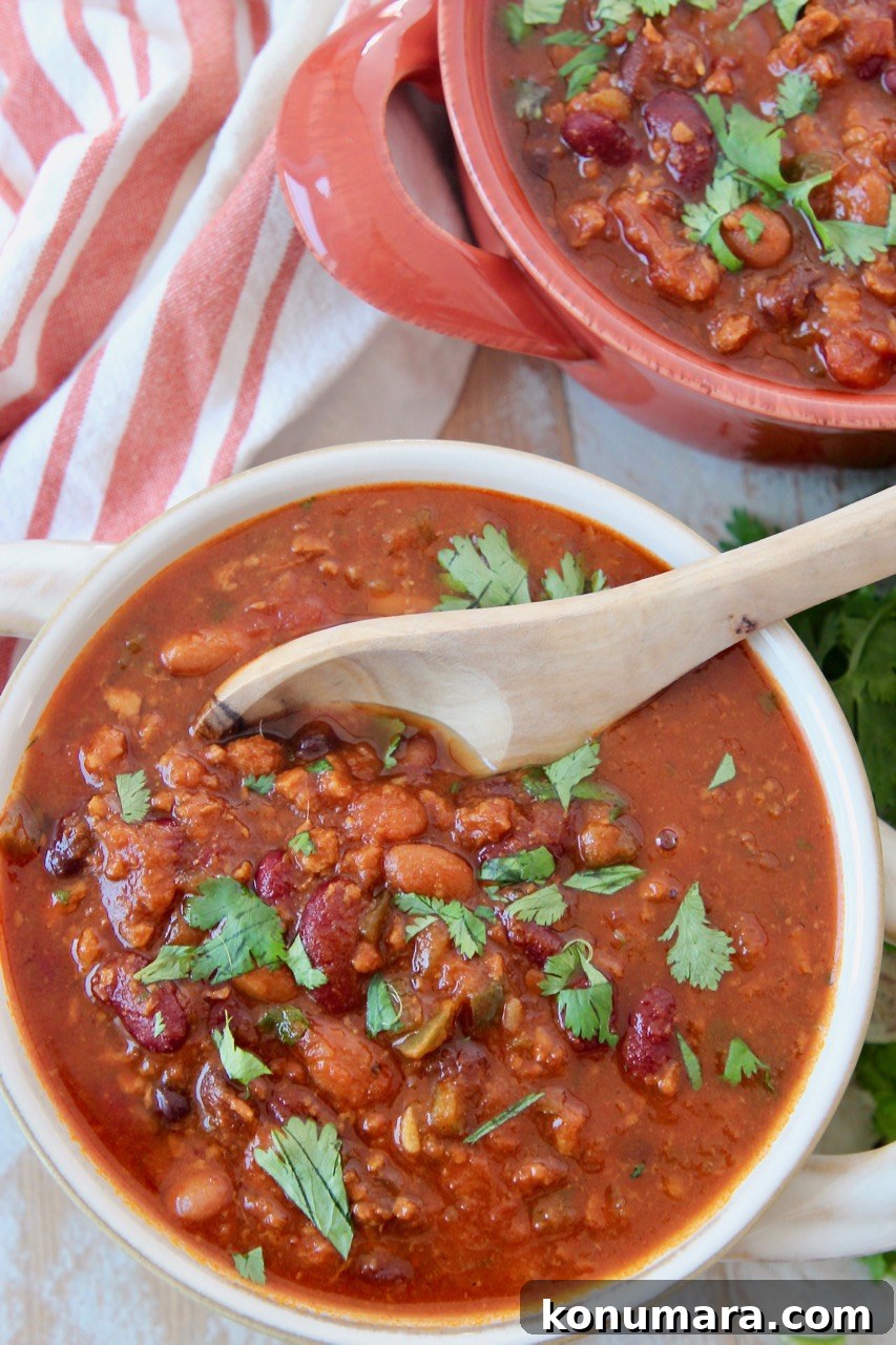 Hearty Slow Cooker Vegan Chili Recipe 6 chili in bowl with wood spoon