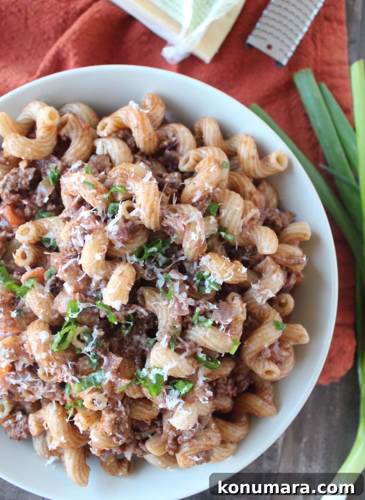 One-Pot Beef and Macaroni Recipe 8 cooked pasta and ground beef in a bowl topped with parmesan cheese