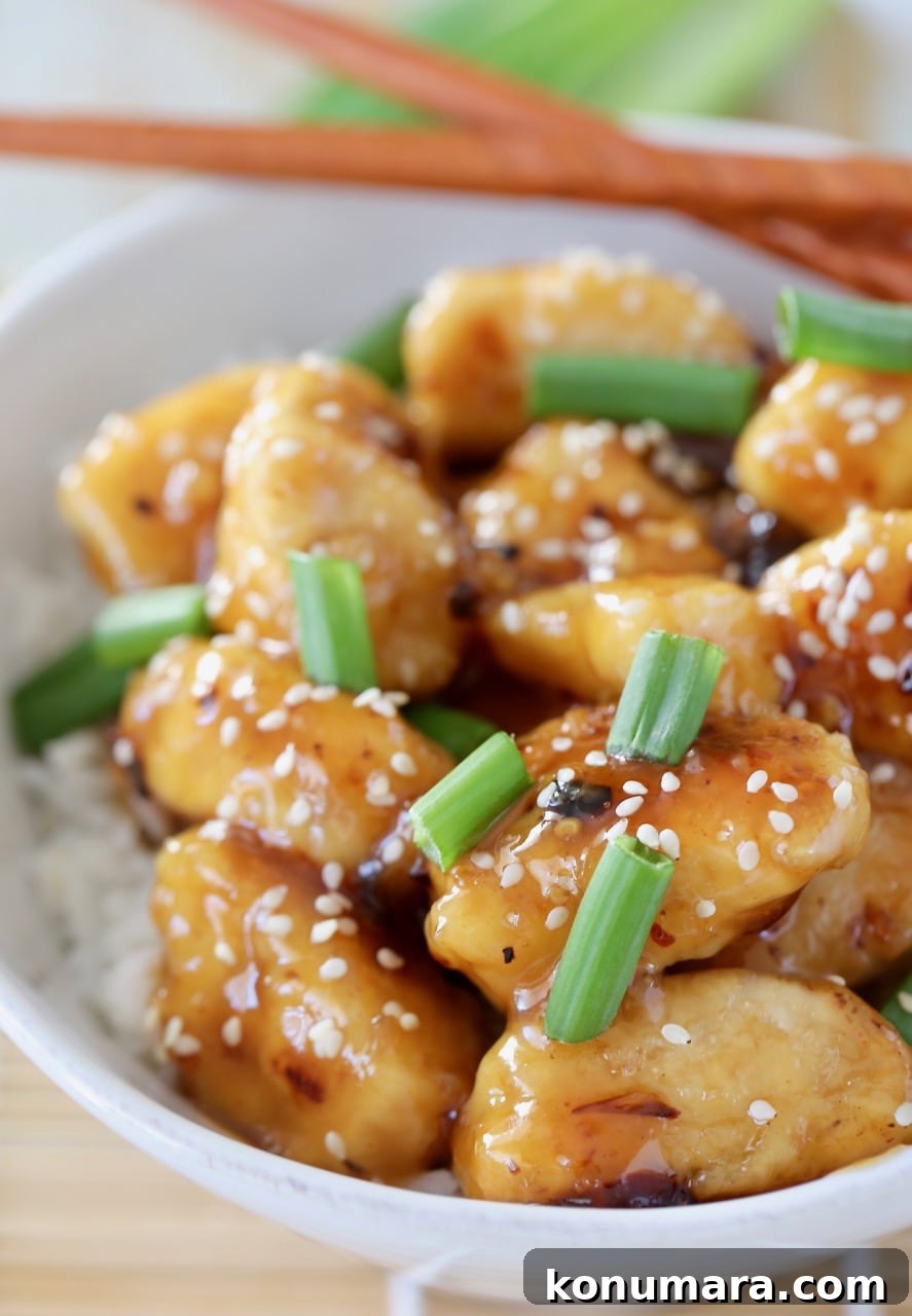 Gluten-Free Chinese Honey Chicken Recipe 6 Chinese honey chicken pieces in bowl, topped with green onions and sesame seeds