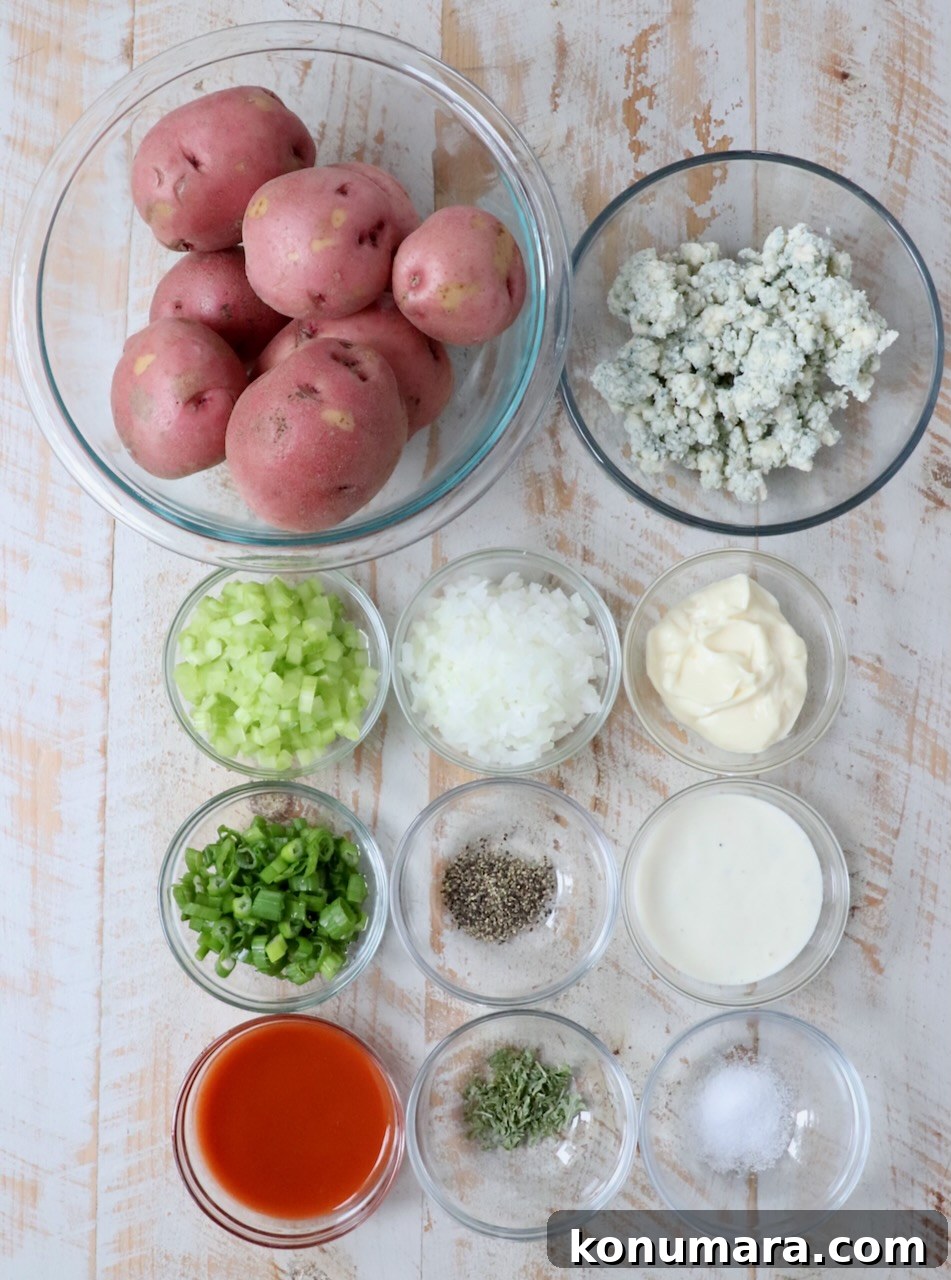 Buffalo Potato Salad with Blue Cheese and Celery 3 ingredients for buffalo potato salad in glass bowls on white wood board