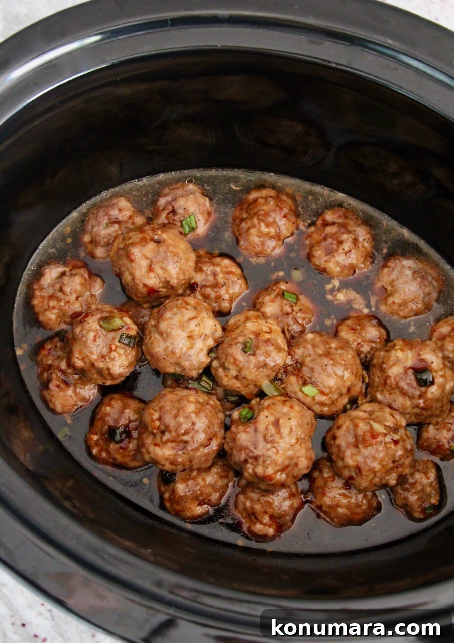 Slow Cooker Korean BBQ Meatballs with Gochujang Glaze 5 Korean BBQ Meatballs, covered in Korean BBQ sauce in a crock pot