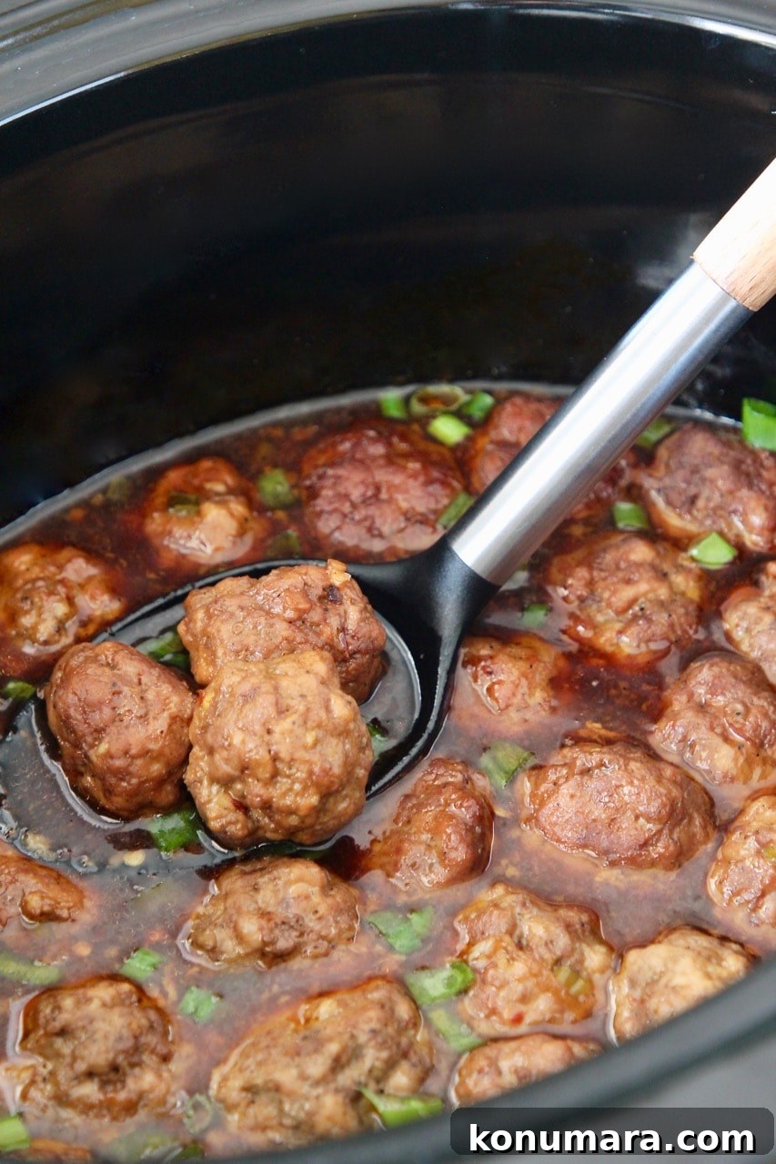 Slow Cooker Korean BBQ Meatballs with Gochujang Glaze 7 Korean bbq meatballs in spoon in crock pot
