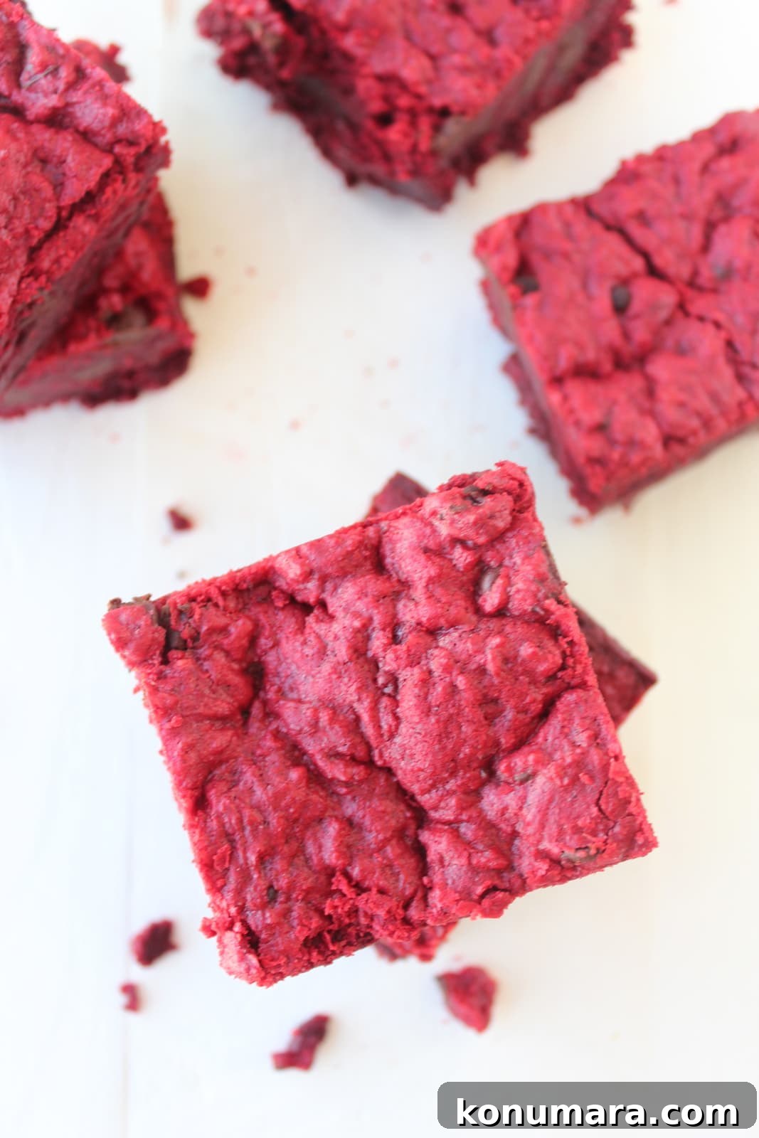 Red Velvet Brookies stacked on top of each other on a white surface. 